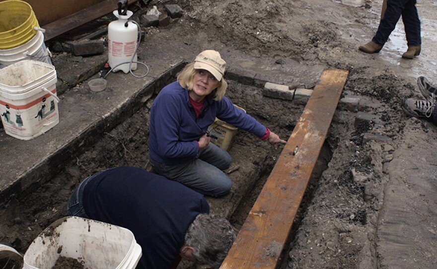 University of Florida archaeologist Dr. Kathleen Deagan helps unearth the bones of the original settlers found on Charlotte Street in St. Augustine when the city dug up a sewer line.