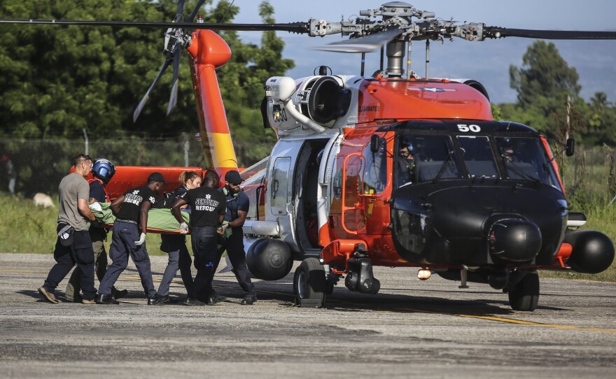 <strong data-stringify-type="bold">Mon., Aug. 16: </strong>A person injured in the earthquake is transferred to a US Coast Guard helicopter in Les Cayes, Haiti.