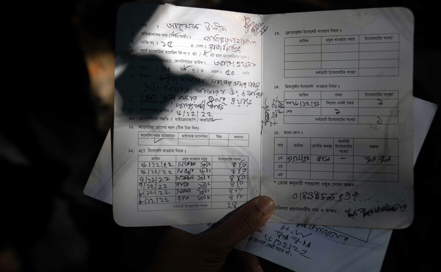 Asha Gudin, a malaria patient in Bangladesh, made a full recovery in three days, thanks to a quick diagnosis from a local health worker and an effective drug called artemisinin. Here, Gudin displays his treatment card.