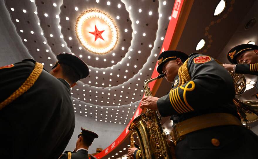 The People's Liberation Army (PLA) band performs during the opening session.