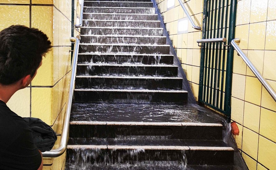 Water runs down the steps of a subway station in Berlin in 2019. Cities in the U.S. and Europe are racing to waterproof older subway systems as climate change drives more rain.