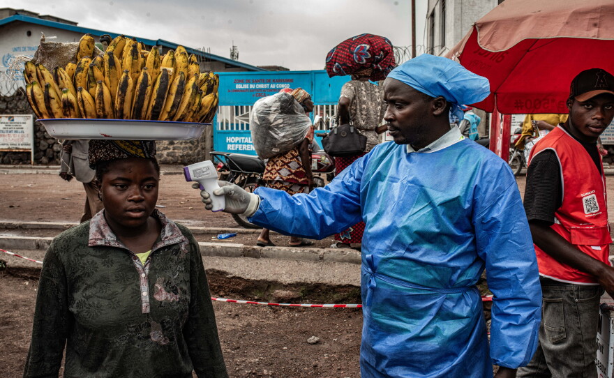 A health worker takes a woman's temperature as part of Ebola screening efforts in Goma, Democratic Republic of Congo. As part of the effort to quash the outbreak, the first patients have been enrolled in a clinical trial to test two drugs against the Bundibugyo strain of the virus that is spreading there. In addition, researchers plan to study whether another drug could protect people exposed to the virus.
