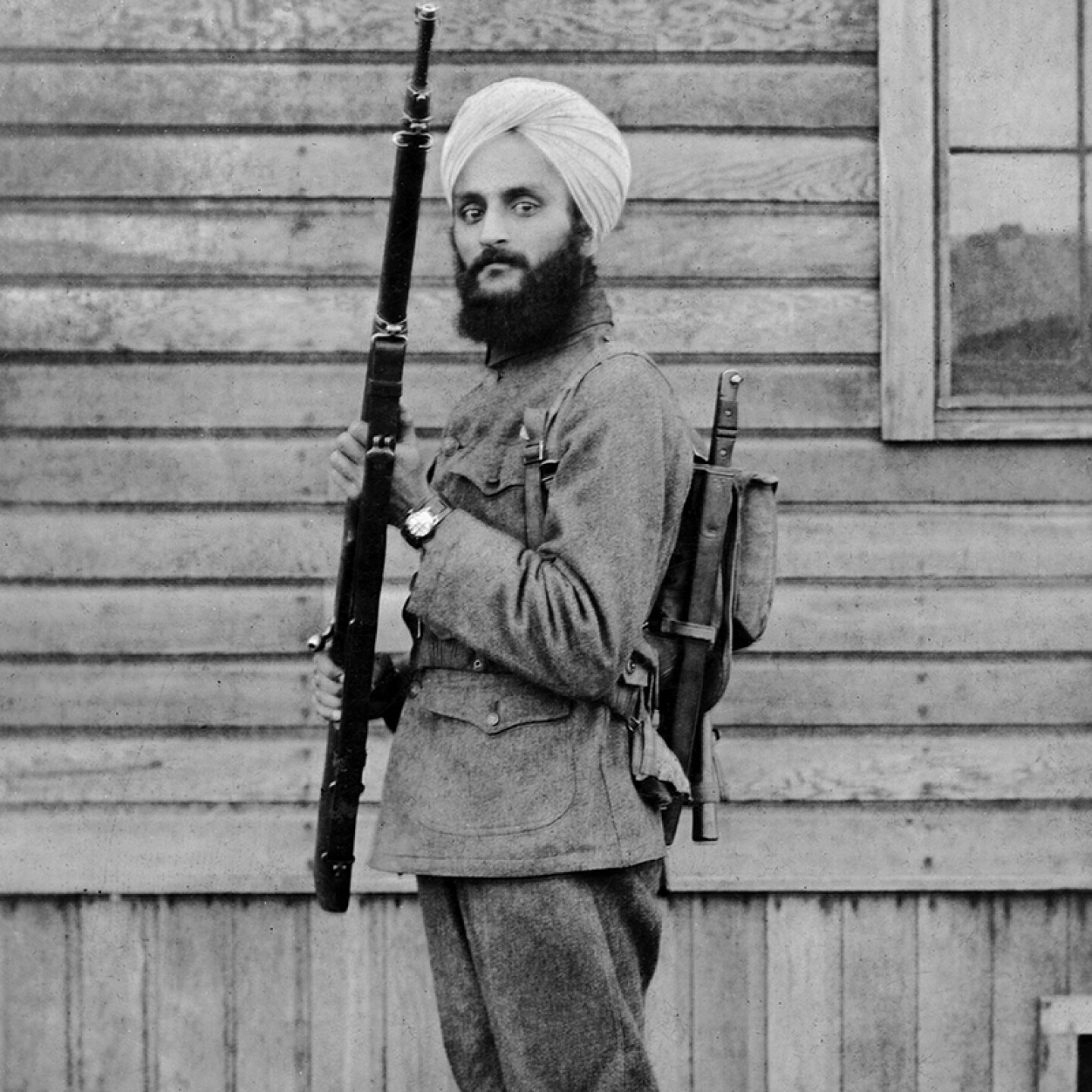 Bhagat Singh Thind as a young man in U.S. Army uniform with rifle, Camp Lewis 1918 (WWI). Thind, a Sikh American, was the first U.S. serviceman to be allowed for religious reasons to wear a turban as part of their military uniform.