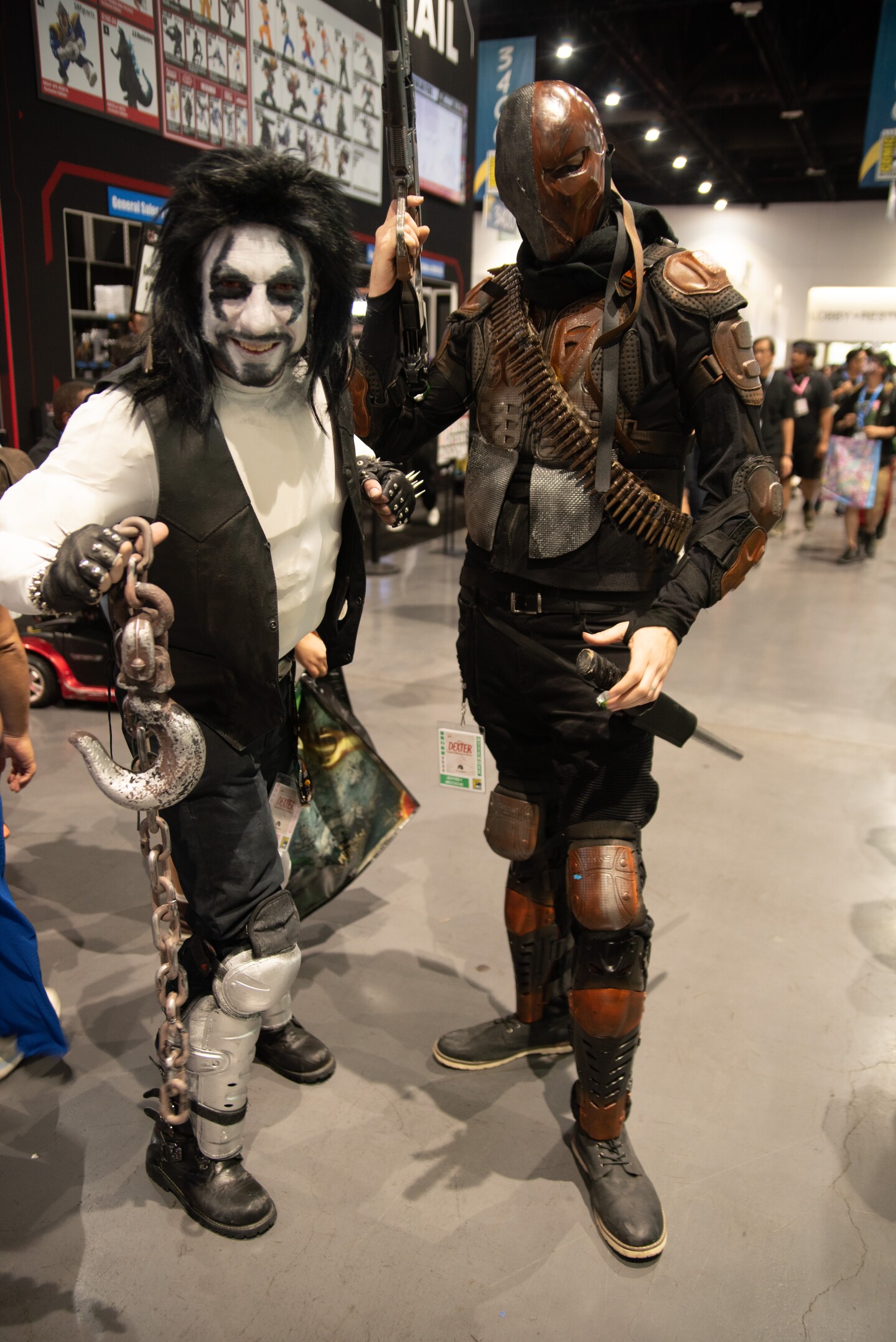 Two cosplayers lean into their DC villain roles as Lobo (left) and Deathstroke (right) on July 25, 2025.