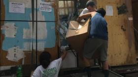 Movers unpack a van at Sarah Taranto's house in May 2017. Many of the Tarantos' possessions arrived damaged, while other had been stolen during the moving process.