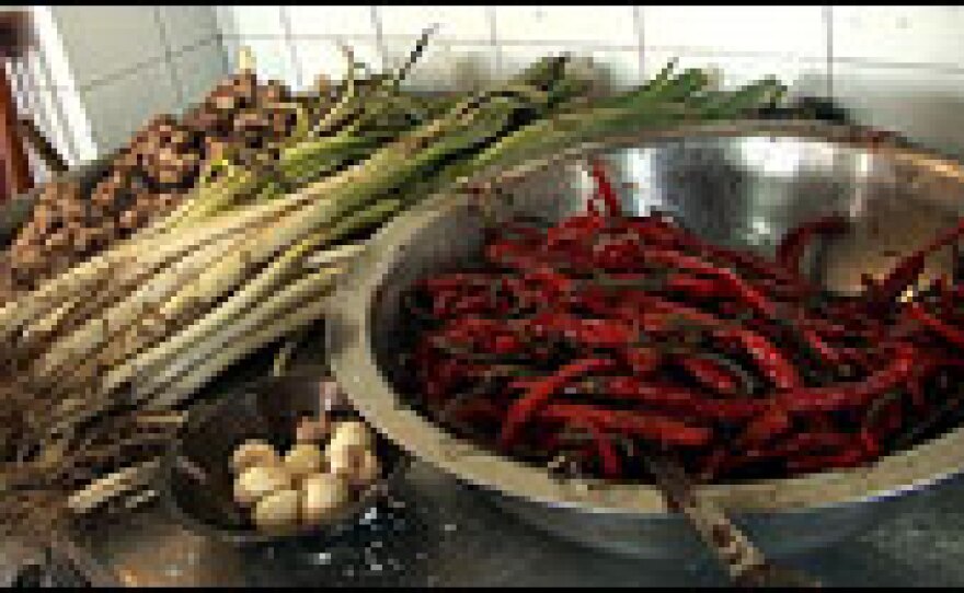 Students cook with ginger, scallions, garlic and chilies.