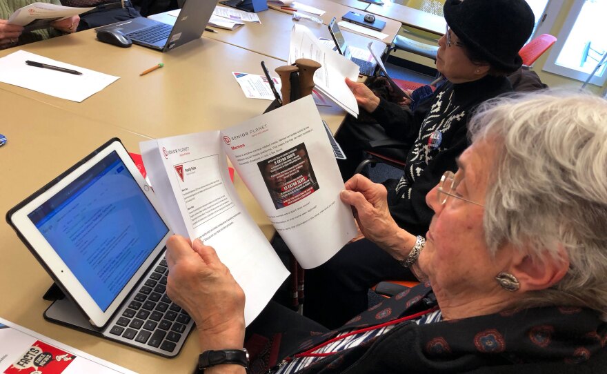 Marlene Cianci looks at a meme about the census. The workshop helps seniors parse the source of an article, fact-check a claim online and discern propaganda from reputable sources.