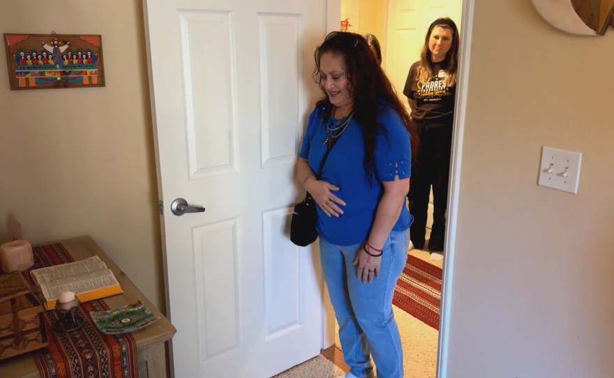 Rita Chavez reacting to the altar Humble Design San Diego set up in her newly furnished bedroom in Chula Vista, CA on Dec. 12, 2024.