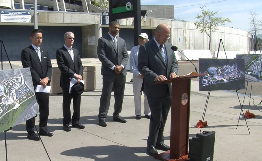 San Diego Councilman Scott Sherman shares his thoughts on a proposed new stadium for the Chargers, April 1, 2015. Standing behind him are Councilman Chris Cate, London Group Realty Advisors president Gary London, former Chargers linebacker Shawn Merriman, and San Diego River Park Foundation executive director Rob Hutsel.