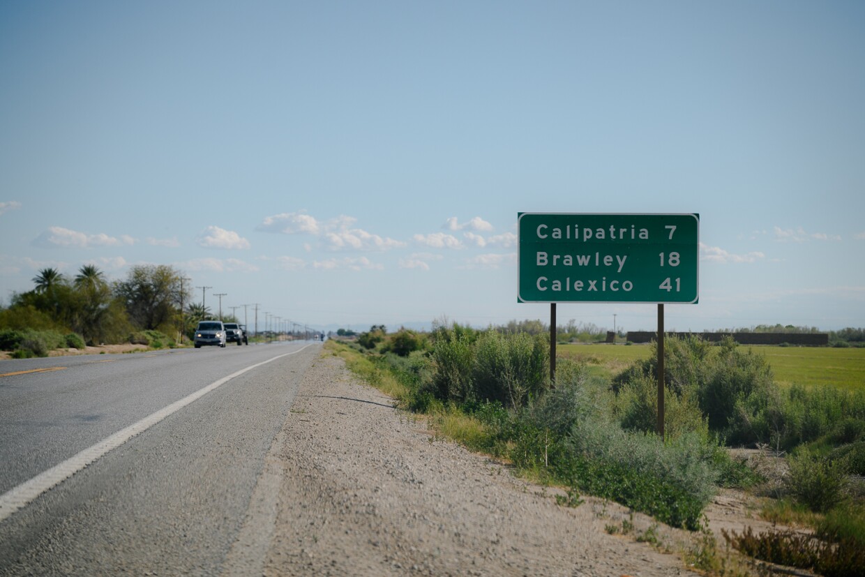 A road sign at the south end of Niland in Imperial County shows the distance to neighboring Calipatria on March 19, 2024. Most days, residents of Niland must travel to Calipatria in order to pick up their mail.