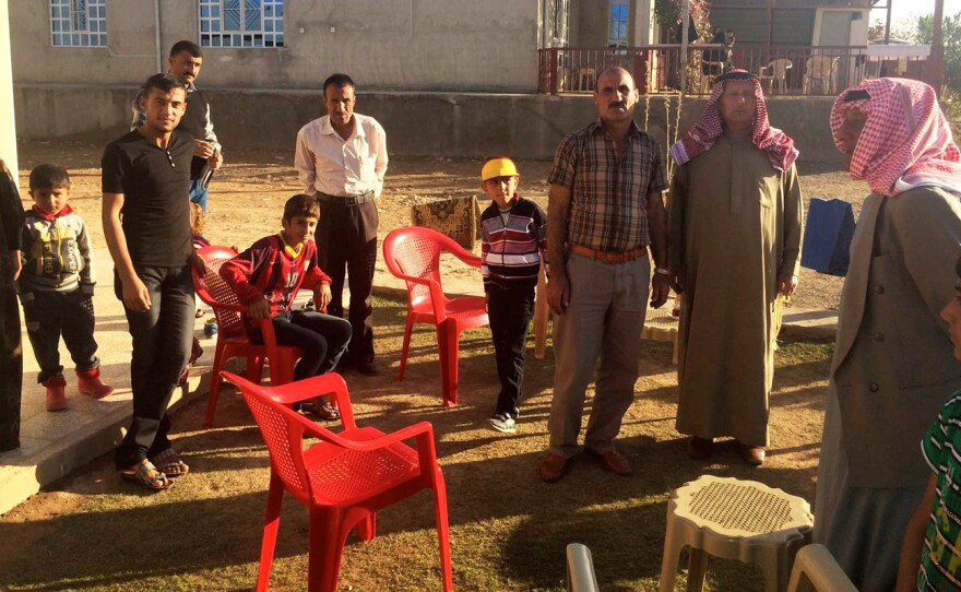 Mohamed Ali stands with his Kurdish family. They are one of the the few families that has returned to Zumar after being driven out by the Islamic State. They say their Arab neighbors should not return.
