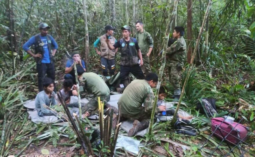 Colombian military forces help four children who survived 40 days in the Amazon jungle after their plane crashed in the department of Caqueta on June 9.