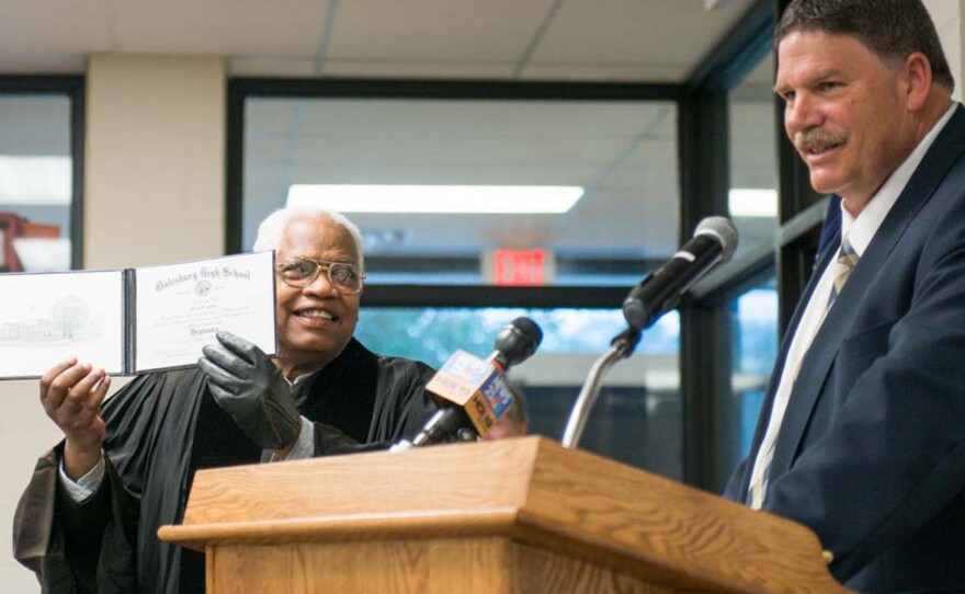 Alva Earley shows off his diploma after receiving it from Galesburg Superintendent Bart Arthur.