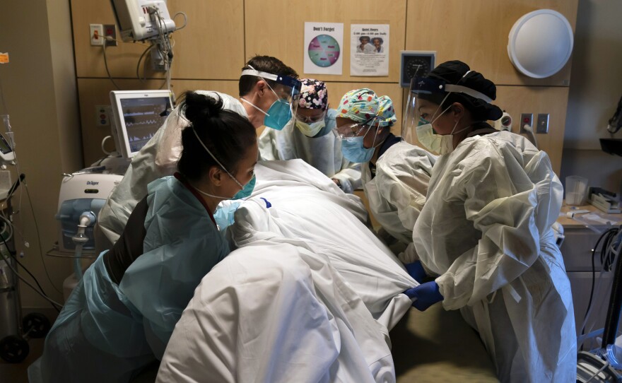 Medical personnel prone a COVID-19 patient last November at Providence Holy Cross Medical Center in the Mission Hills section of Los Angeles.