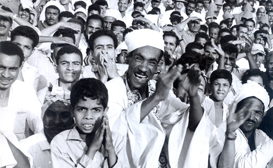 A crowd of men celebrating after Egyptian President Gamal Abdel Nasser announced the nationalization of the Suez Canal in 1956.