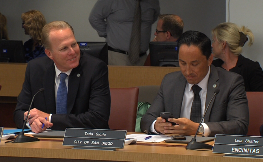 San Diego Mayor Kevin Faulconer, left, and City Councilman Todd Gloria sit at a meeting of the SANDAG board, April 29, 2016.