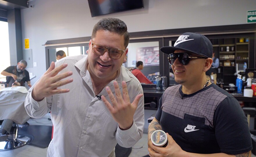 Host Jorge Meraz shows off his new haircut from a barber shop in Tijuana, Mexico.