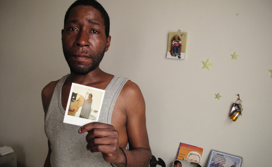 Robert Williams, 42, holds a photo of his late mother Judy Williams.