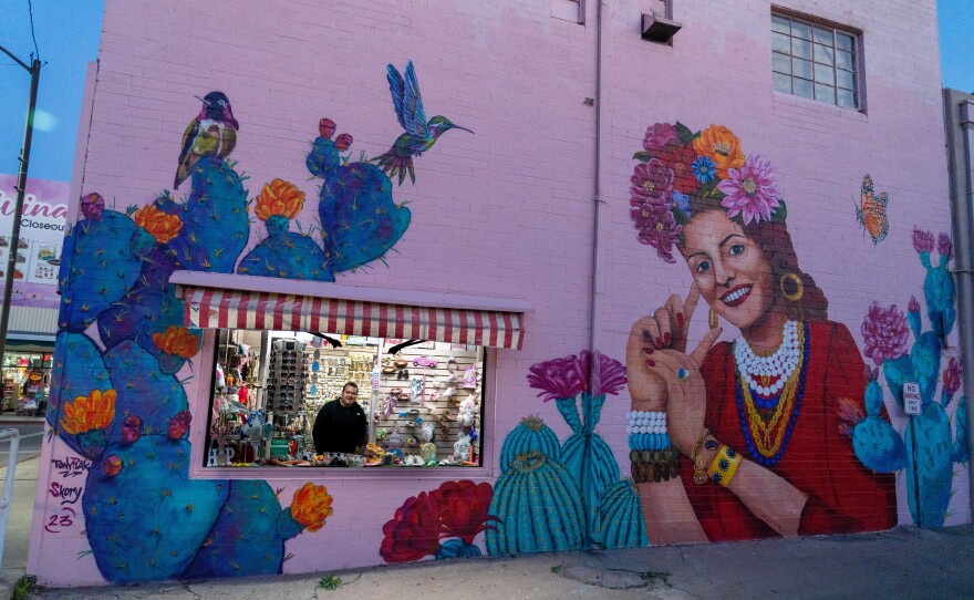 Evan Kory, one of the owners of La Cinderella and Kory bridal store, peers out of the window as the shops close in downtown Nogales.