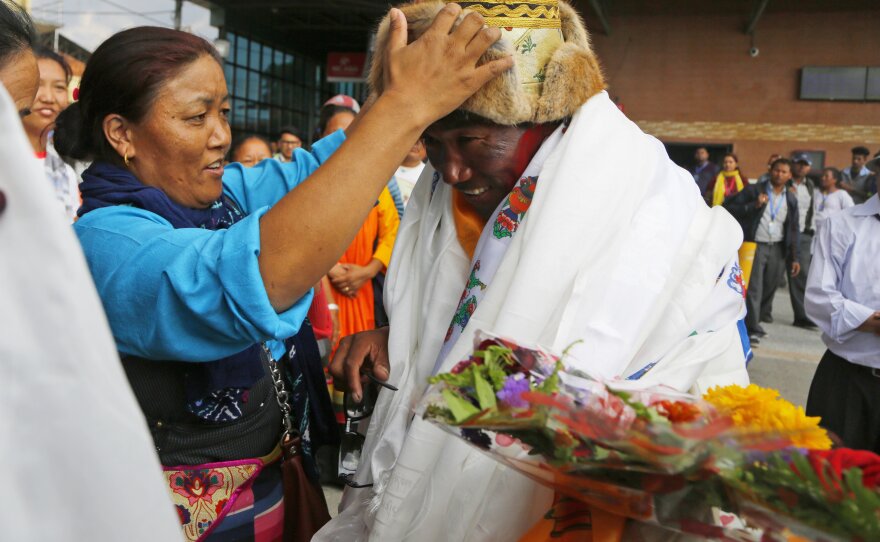 Friends and family congratulate Kami Rita, 48 at the time, in Kathmandu, Nepal, in May 2018 after setting a new world record for climbing Mount Everest 22 times.