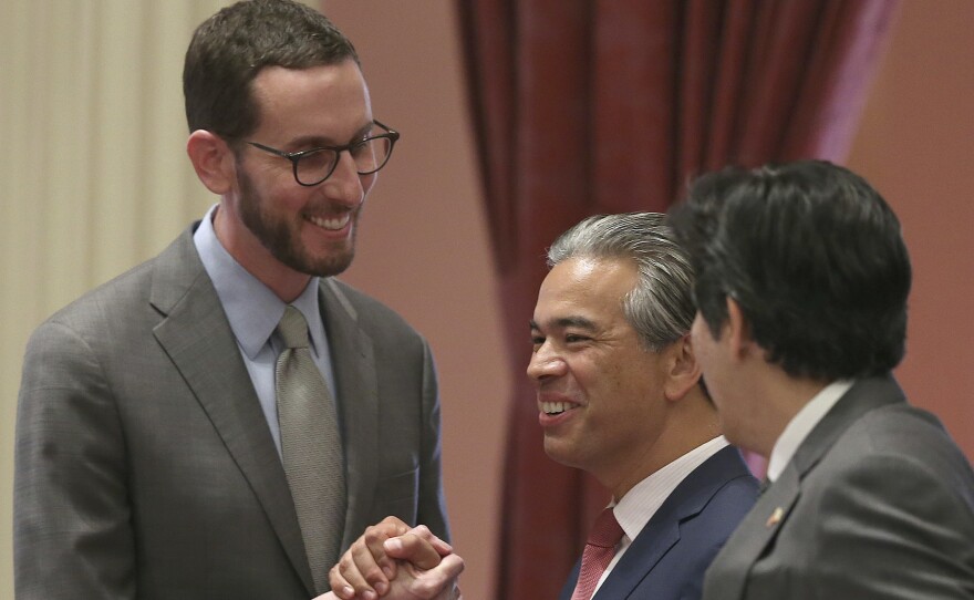 State Sen. Scott Wiener, D-San Francisco, left, receives congratulations from Assemblyman Rob Bonta, D-Alameda, center, and Sen. Kevin de Leon, D-Los Angeles, right, after passage of a bill in Sacramento, Calif. in this undated photo.