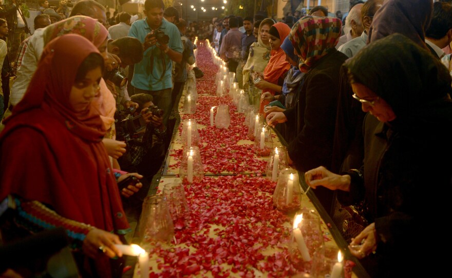 Pakistani female activists of Muttahida Qaumi Movement light candles for the victims of an attack by Taliban gunmen on a school in Peshawar, in Karachi on Tuesday.
