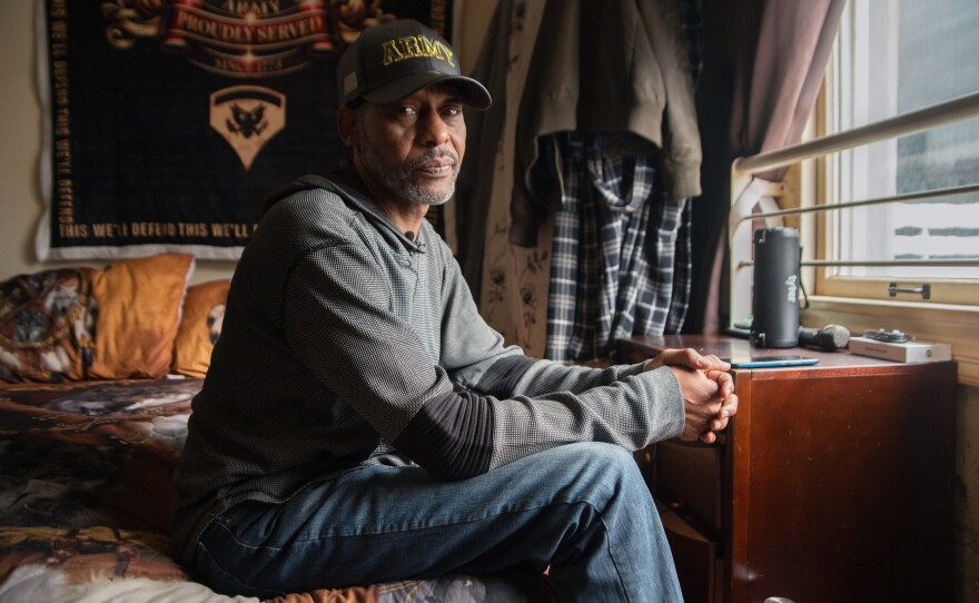 Calvin Neal sits inside his single-room occupancy at the Hotel Churchill in downtown San Diego on Friday, Oct. 3, 2025.