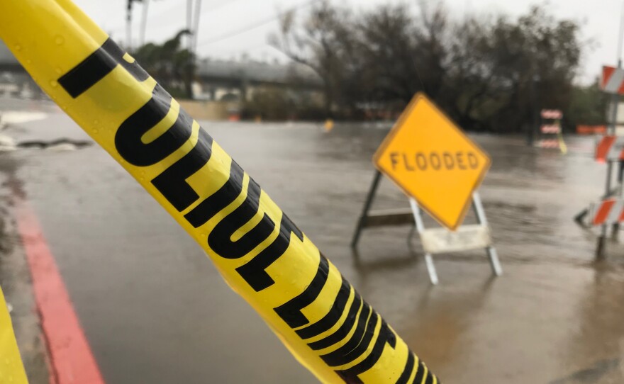 Police tape was placed on flooded roads in Mission Valley during a winter storm, Feb. 14, 2019.