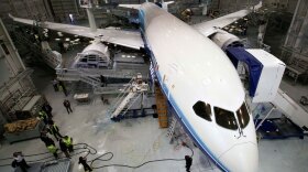 A Boeing 787 Dreamliner sits in a paint hangar at the plant in Everett, Wash. Despite fanfare over its debut, it has yet to have its first test flight.