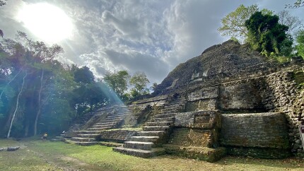 Maya pyramid at Lamanai Belize with sunlight from angle. 