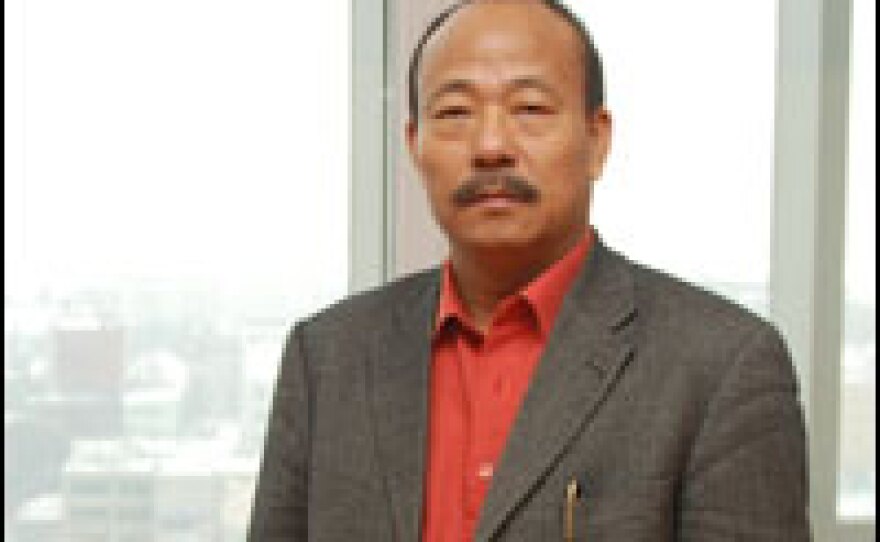 He Wenyan, director of the Hua Fu construction company, stands at the top of his Asia Hotel, Blagoveshchensk's tallest building by far. He dominates construction in the city.