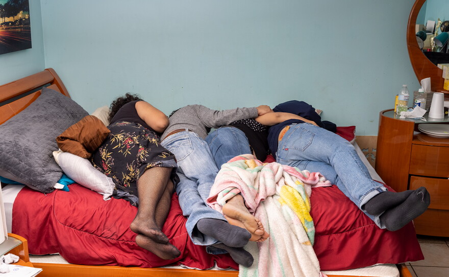The Villanueva family on their queen-size bed after Jennifer and her brother, Oliver Villanueva, returned for Thanksgiving break in 2021.