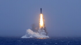 In this photo released by Xinhua News Agency, a long-range ballistic missile bursts out of the sea during a test launched from a Chinese nuclear-powered submarines in the South Pacific on Monday.