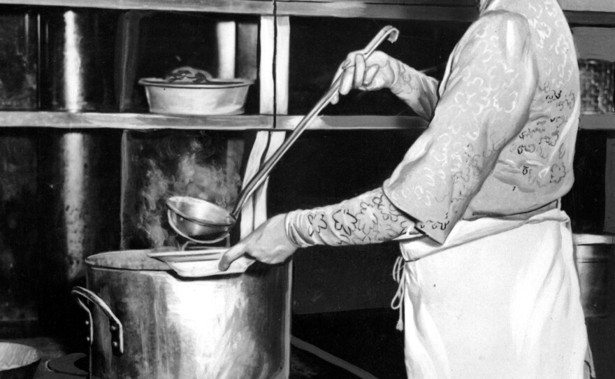 Eleanor Roosevelt ladles soup into a bowl to help feed unemployed women in the Grand Central Restaurant kitchen in New York City in 1932 during the Great Depression.