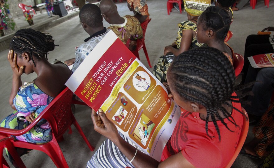 A woman reads about Ebola during a prevention campaign by UNICEF at the Mission for Today Holy Church, in Monrovia, Liberia, on Sunday.