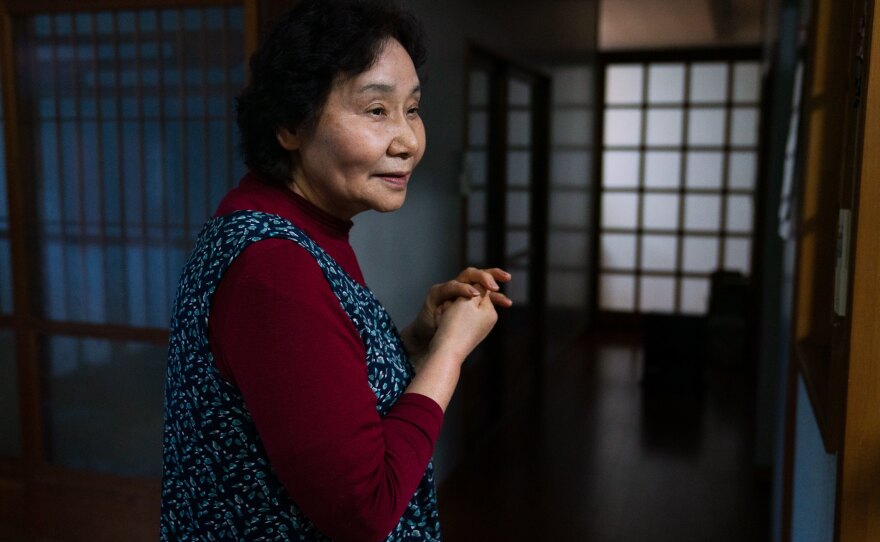 Yuriko Kanno, 75, is amused by the battle between her husband and the monkeys.