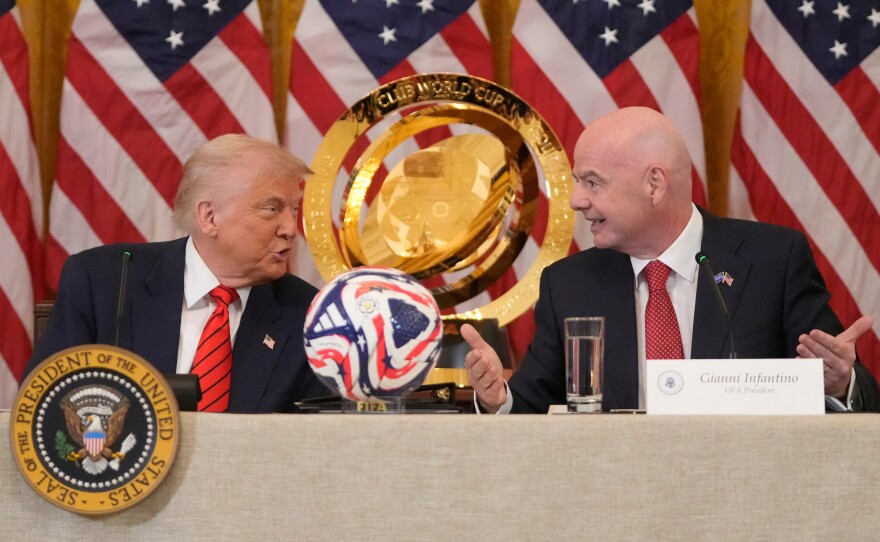 President Trump and FIFA President Gianni Infantino talk during a FIFA task force meeting in the East Room of the White House, May 6, 2025, in Washington.