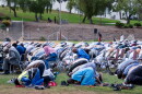 Community members kneel and pray at Colina Park on Eid Al-Adha, May 27, 2026.