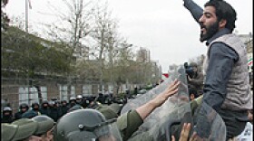 Iranian riot police prevent hardline students from approaching the British embassy in Tehran during a protest Sunday. The students are demanding the trial of 15 British sailors and marines.
