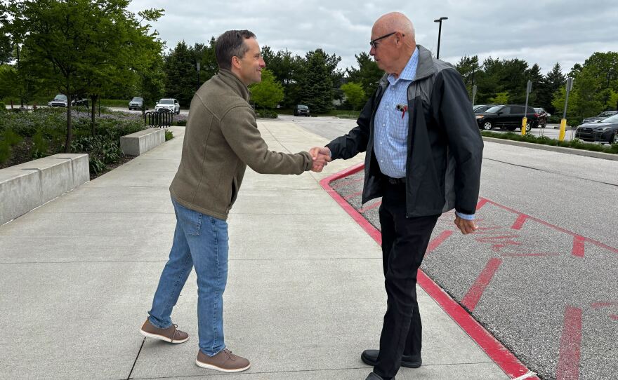 Outside a polling place in West Lafayette, Ind., Republican state Sen. Spencer Deery greets voters arriving for early voting on April 28. Deery is a Republican incumbent President Trump has targeted after he opposed the president's redistricting push in Indiana.