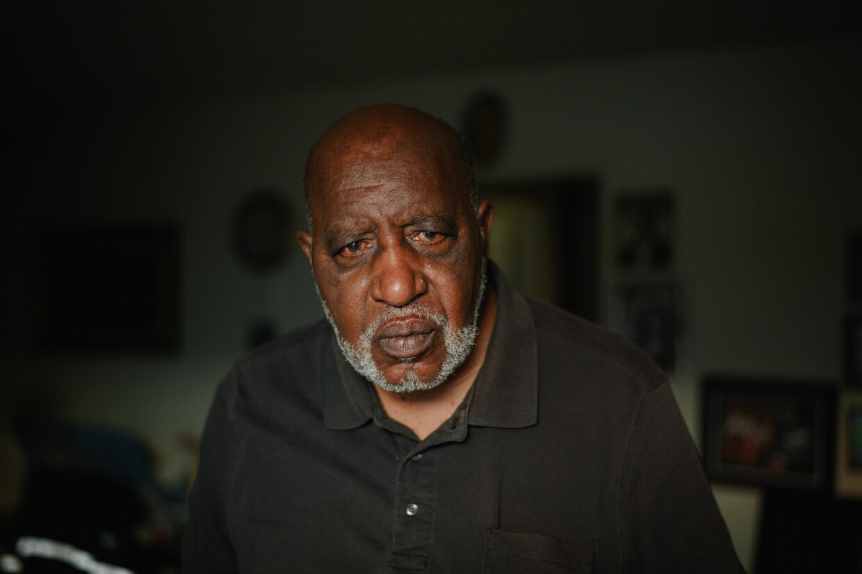 Sherman Qualls sits for a portrait inside his home at The Swell apartments, formerly Sussex Gardens, in Imperial Beach, California on Nov.18, 2024. Qualls, a retired bus driver, has lived in the building for 18 years.