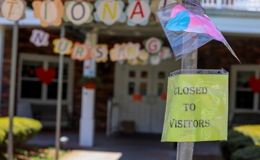 A sign posted near the entrance to the Kimberly Hall South nursing home shows the home closed to visitors, Thursday, May 14 in Windsor, Conn. The coronavirus has had no regard for health care quality or ratings as it has swept through nursing homes around the world, killing efficiently even in highly rated care centers.