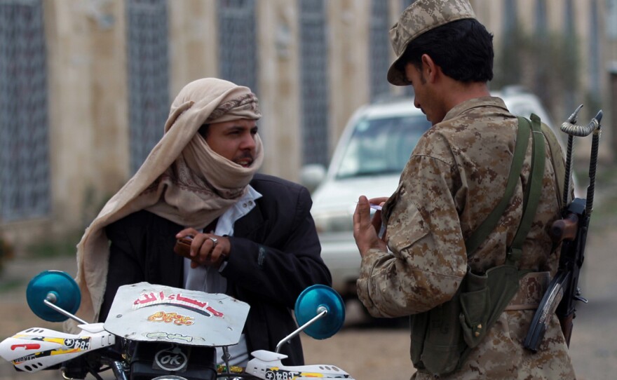 A Yemeni soldier speaks with a motorcyclist amid tightened security near Sanaa International Airport on Tuesday.