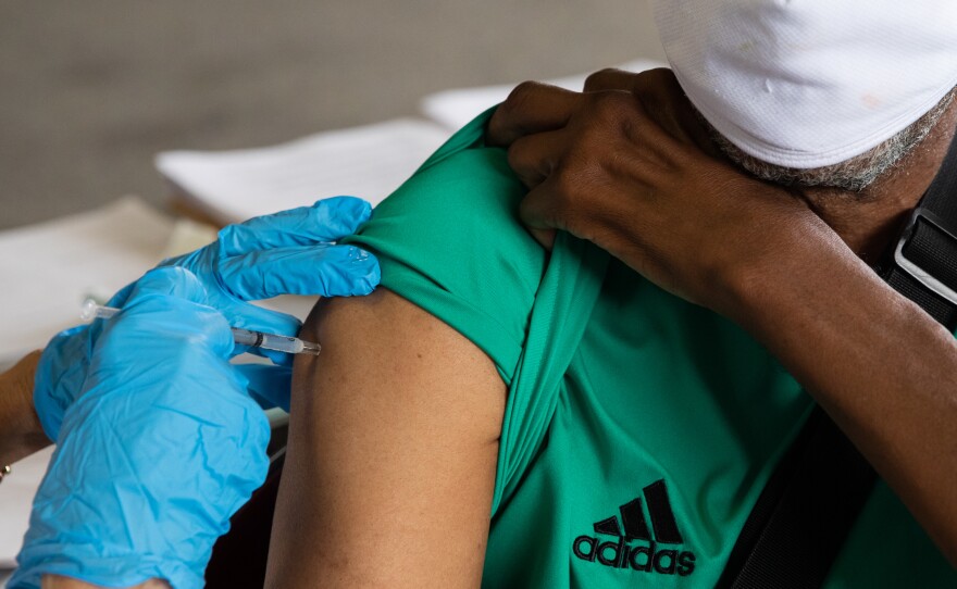Rufus Peoples receives a dose of the Pfizer-BioNTechCOVID-19 vaccine at an Oakland County Health Department vaccination clinic in Southfield, Mich., in August.