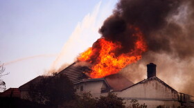 A roof engulfed in flames is seen during the Norte Fire on Friday, Oct. 16, 2026, in San Juan Capistrano, Calif.