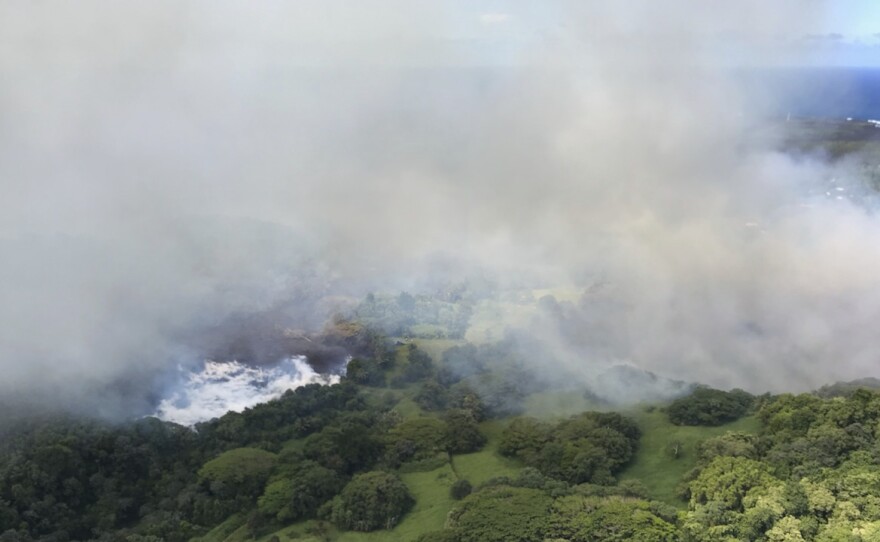 Lava steams after it hit Hawaii's Green Lake, which had been filled with water hours before, on Saturday.