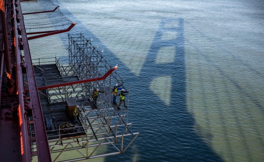 Workers install a stainless steel safety net below the sidewalk on the Golden Gate Bridge on Jan. 8, 2024. The net is designed to discourage people from jumping and to catch those who do.