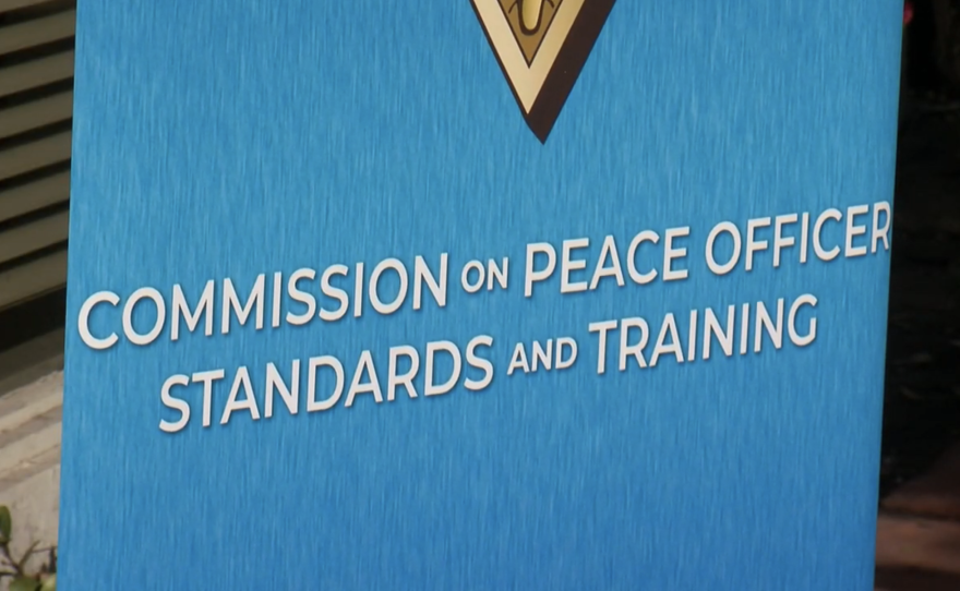 A sign outside of a California Commission on Peace Officer Standards and Training hearing in San Diego on March 6, 2025.