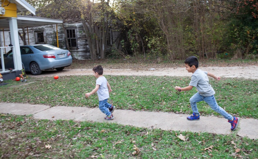 Arion, 5, chases Azaiah, 2, Sunday, November 21, 2021 in the front yard of the house that their family moved into in May of 2021.