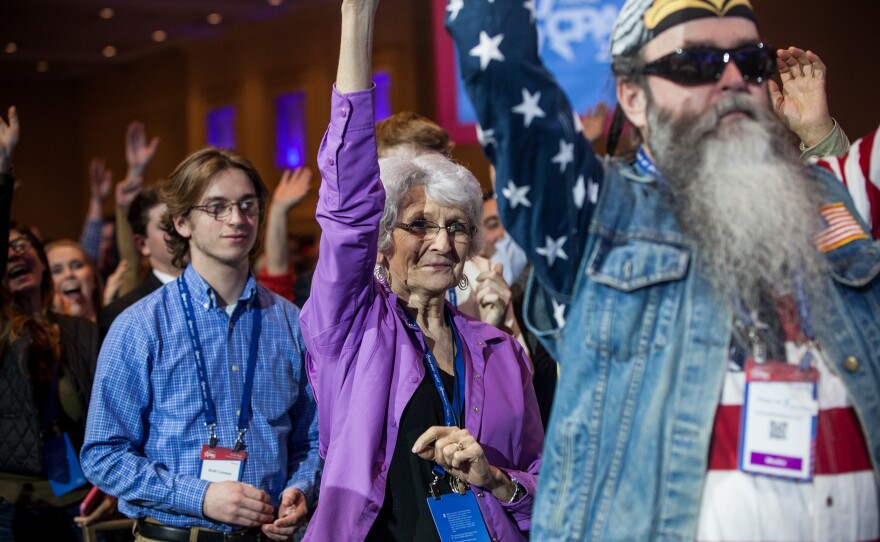 Attendees cheer during a special taping of "Hannity" on the first day of the conference.